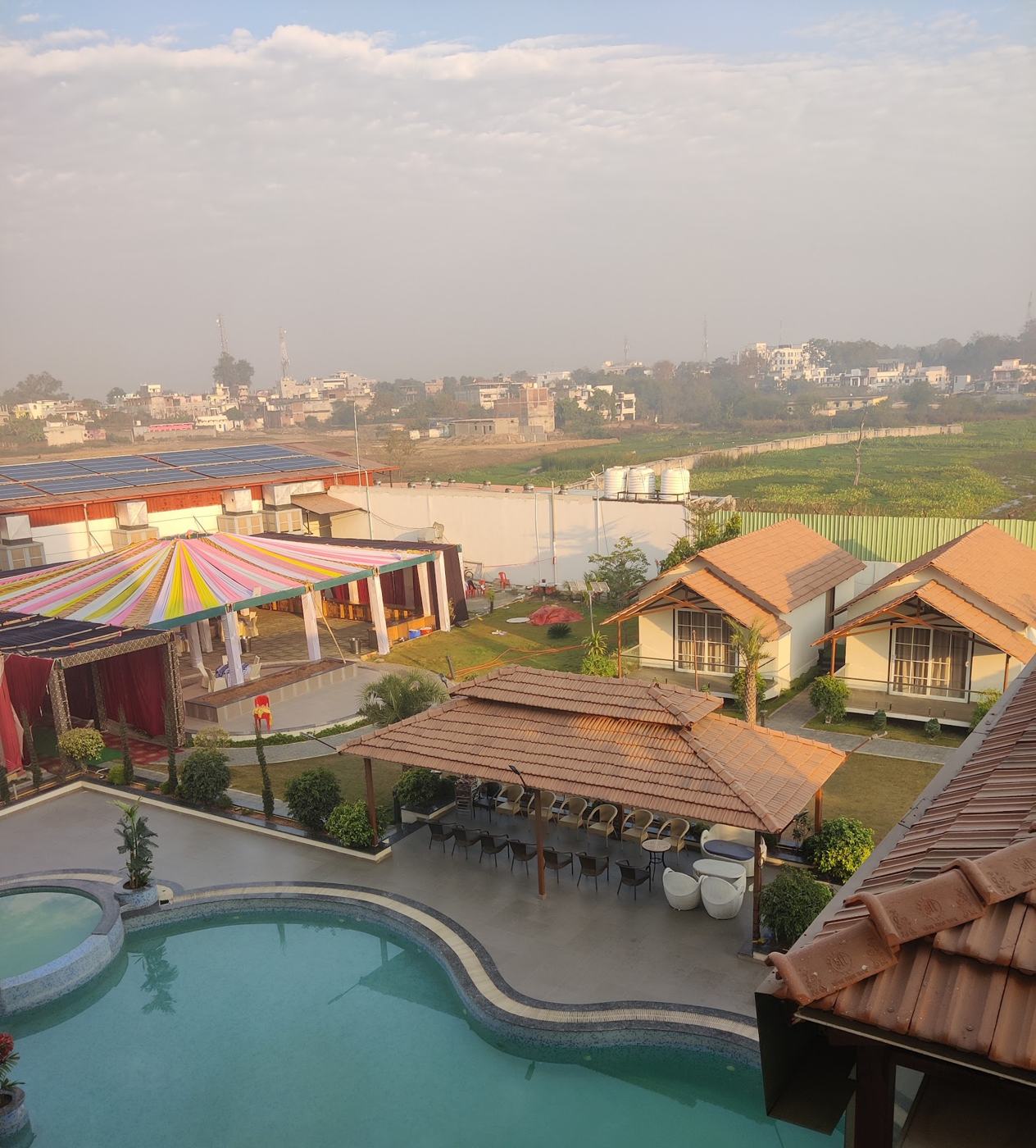 Aerial view at dusk over the pool, gazebo and lake