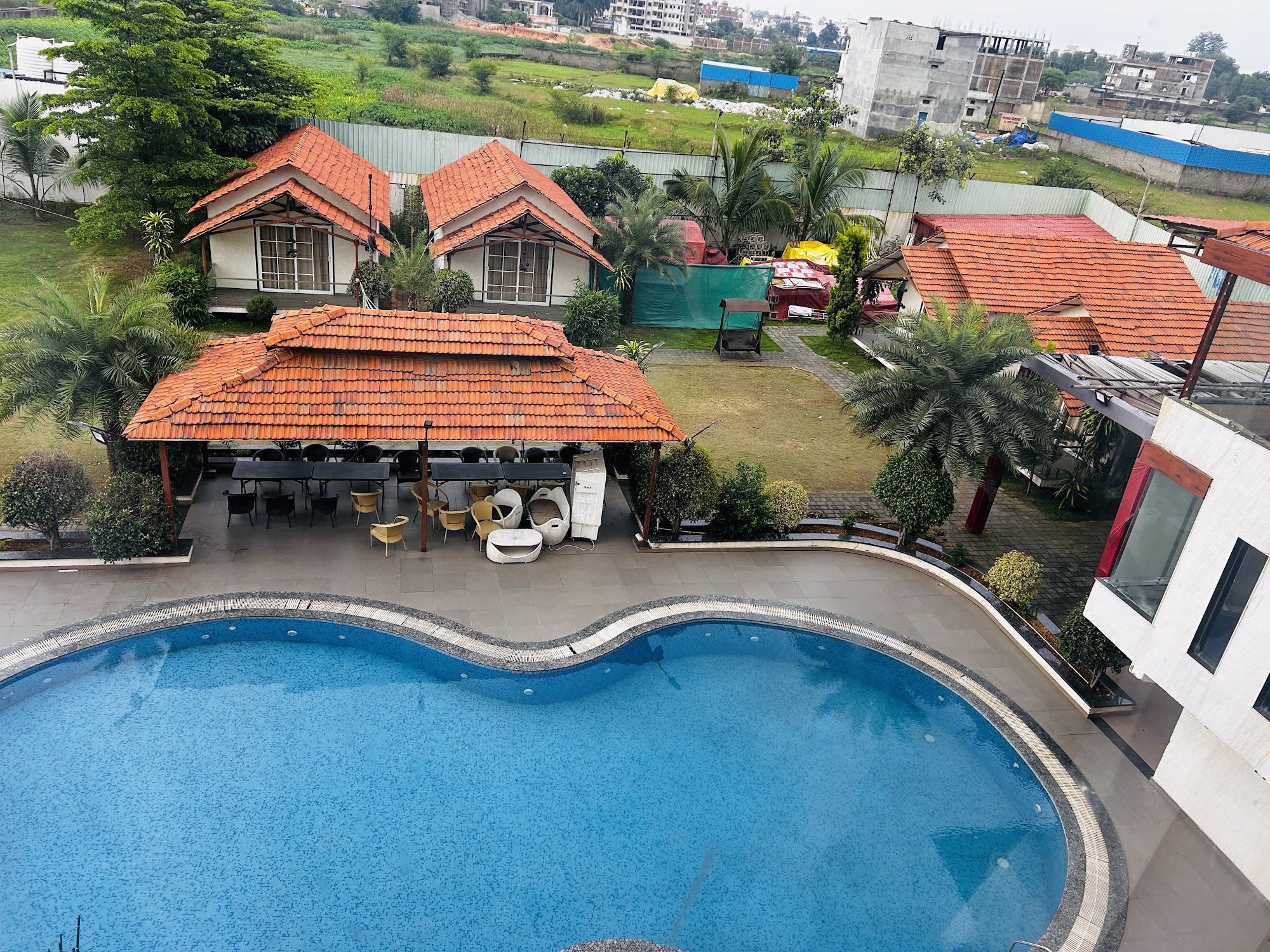 Aerial view of the kidney-shaped pool, gazebo and cottages