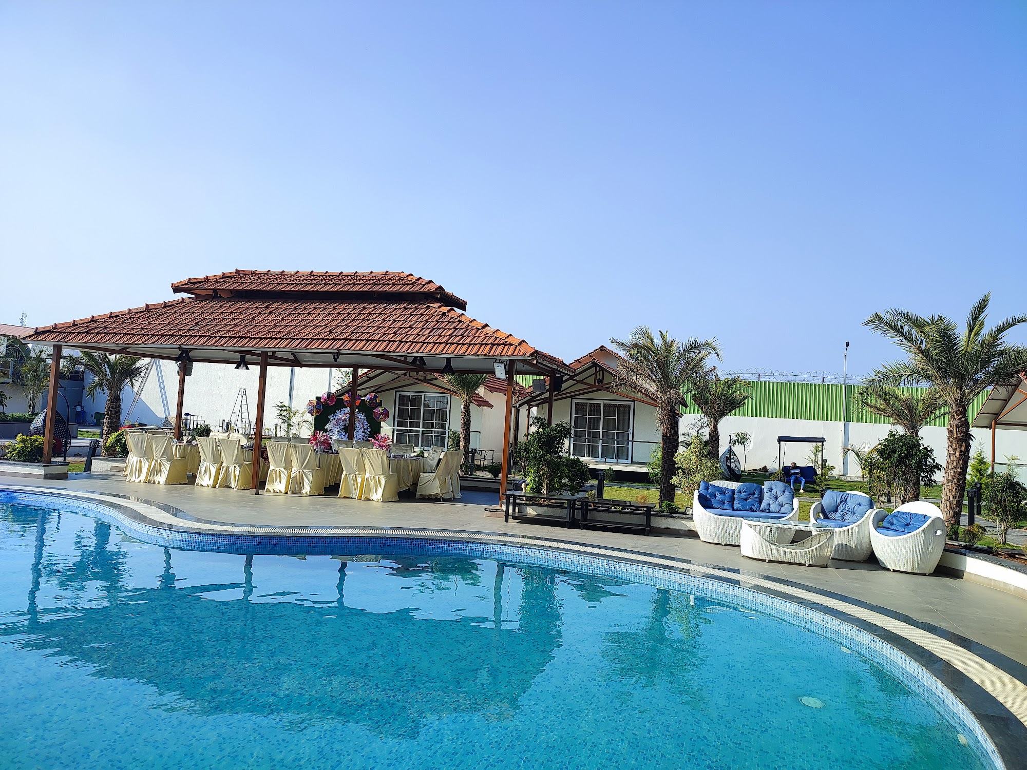 The pool and tiled-roof gazebo on a clear morning