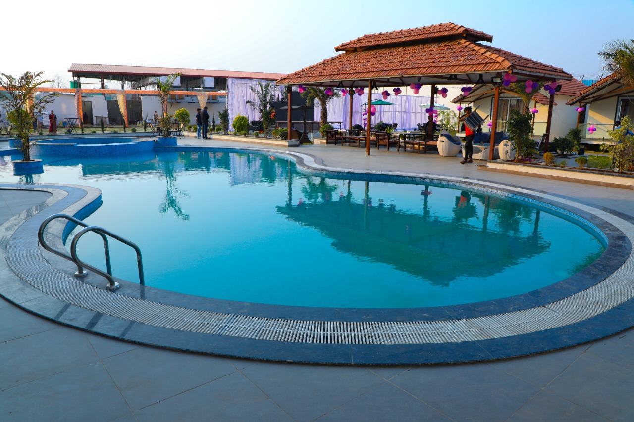 Wide view of the pool with lounge chairs